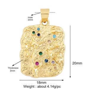 Detailed view of rectangular hammered gold pendant with floral motifs and zircon stones
