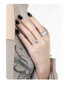 Detailed close-up of a silver S925 ring featuring a round blue zircon and micro-pave setting