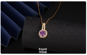 Macro shot of gold necklace featuring a purple zircon heart pendant with halo diamonds