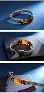 Detailed views of braided titanium steel bracelet with amber resin centerpiece and clasp