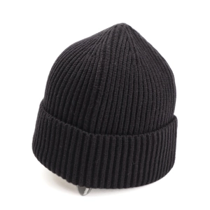 Detail shot of the thick ribbed knit texture on a black cuff winter beanie cap