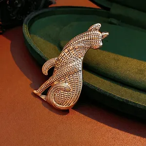 Luxury vintage wolf head brooch in golden finish with intricate geometric engraved textures