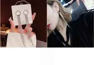 Detail view of long tassel earrings with S925 silver needle and sparkling rhinestones