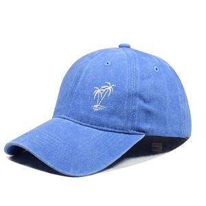 Detail of light blue washed cotton baseball cap with white coconut tree embroidery