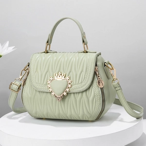 Elegant mint green seashell shoulder bag with quilted wave texture and heart clasp