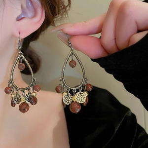 Bohemian drop tassel earrings featuring bronze metal frame and marble reddish beads