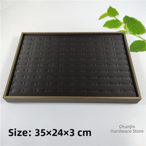 Detail view of a 35x24x3cm jewelry display tray with bronze metal frame and black velvet