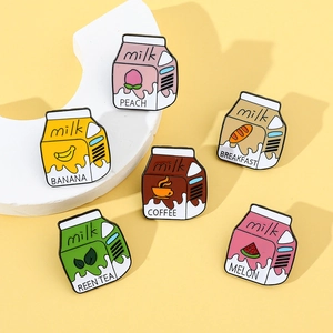 Detailed close-up of six colorful milk carton enamel pins in various fruit flavors