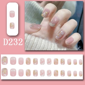 Macro detail of pink press-on nails with 3D bows, gold foil, and shell textures