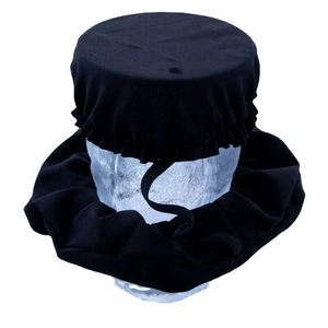 Elastic drink cover and scrunchie set in black fabric displayed on a skull model