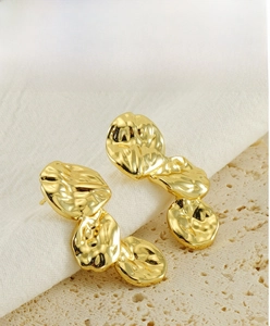 Detailed close-up of gold-plated petal stud earrings with irregular wrinkled texture