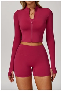 Detail of high-stretch magenta yoga set featuring thumbholes and stand-up collar design
