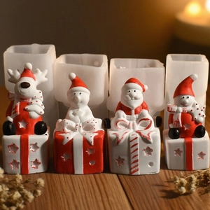 Christmas silicone molds featuring snowman, reindeer, and Santa with red gift box bases