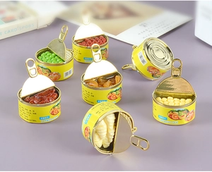 Makro-Detail von Miniatur-Lebensmitteldosen-Modellen mit Texturen und goldenen Ringen