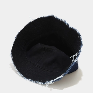 Deep blue denim bucket hat with distressed raw edges and vintage patchwork design