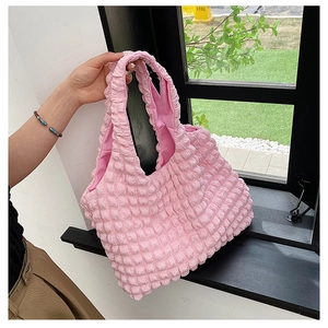 Detail of light pink popcorn texture tote bag showing high-elastic pleated fabric surface