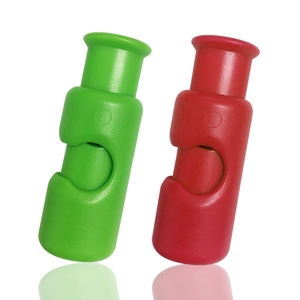 Close-up of green and red plastic spring cord locks with polished finish on white background