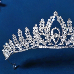 Silver bridal crown with rhinestone leaves for weddings on deep blue background