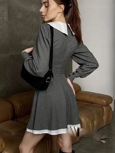 Detail of French style mini dress with white doll collar and buttoned lantern sleeves