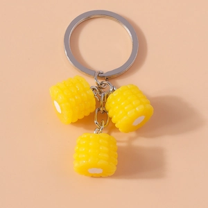 Detailed view of artificial yellow corn pendants on a silver-tone keychain accessory