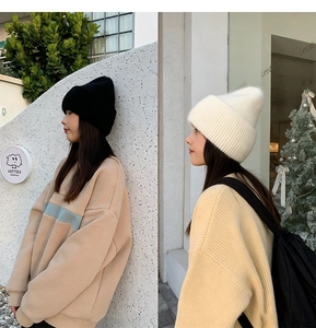 Side view of soft rabbit fur knit beanie in black and white colors for winter warmth