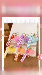 Detailed view of colorful luminous lollipop keychains with shiny sequins and Good Luck straps