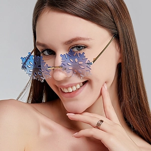 Detail of rimless snowflake sunglasses with gradient blue lenses and gold metal temples