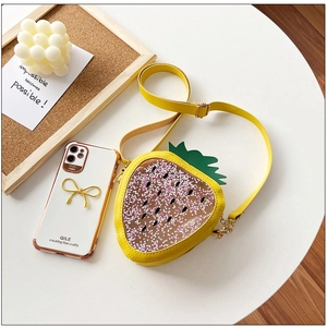 Close-up of strawberry-shaped yellow jelly bag with pink star sequins and PVC window