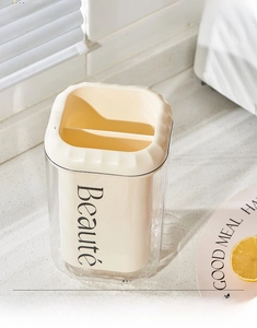 Modern cream-colored cutlery holder with dual compartments and transparent outer shell