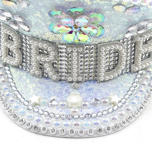 Close-up of sparkling silver captain hat with pearl Bride lettering and rhinestone flowers