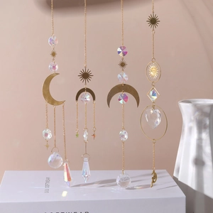 Detail of suncatchers with gold moon and star metal frames and sparkling crystal prisms
