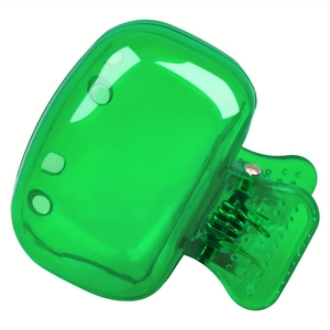 Close-up of green translucent jelly hair clip with a smooth finish and metal spring