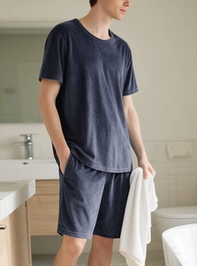 Detail of navy blue velvet loungewear set with soft texture on men's T-shirt and shorts