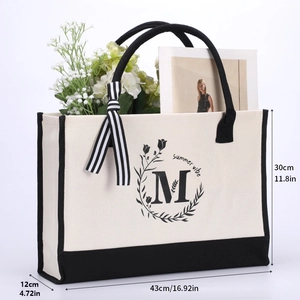 Detail of cotton canvas tote bag with black handles and summer vibe floral print