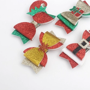 Detailed view of sparkly Christmas bow clips featuring sequins and festive holiday designs