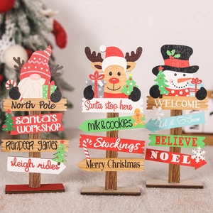 Detailed view of three festive wooden Christmas signs featuring a gnome, reindeer, and snowman