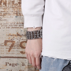 Close-up of retro silver hip hop skull bracelet with four rows of gothic steel detail