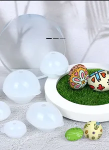 Detail of egg and sphere silicone molds with finished decorative Easter resin crafts