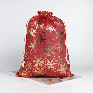 Red Christmas drawstring burlap gift bag with gold snowflake pattern and white rope closure