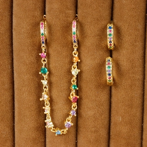 Macro shot of 18K gold plated linked earrings with multi-colored cubic zirconia in velvet tray