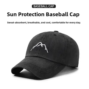 Close-up of white mountain embroidery on black washed cotton vintage baseball cap
