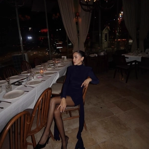 Elegant navy blue long sleeve bodycon dress with ruching and flowing streamers detail