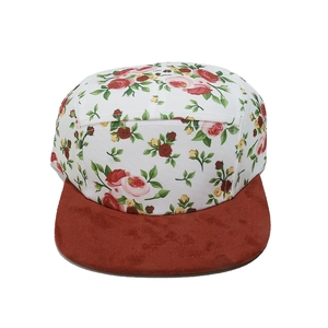 Detail of five-panel floral camper hat with white canvas and brown suede flat brim