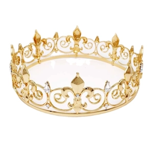 Luxurious gold round king crown with hollow design and sparkling crystals on white background