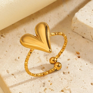 Adjustable golden heart open ring with textured finish on marble and silk background