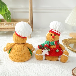 Plush Gingerbread Man Christmas doll with chef hat and striped scarf on home background