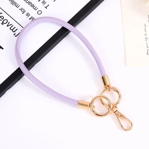 Close-up of light purple leather wrist strap with gold spring ring and lobster clasp