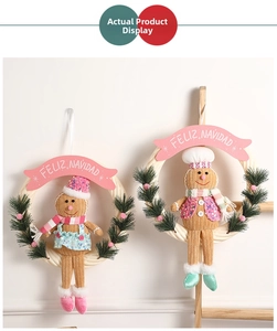 Detail of Christmas gingerbread man wreaths with Feliz Navidad banners and pine needles