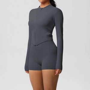 Detail of slim fit dark gray yoga set showing side profile and zipper tailoring