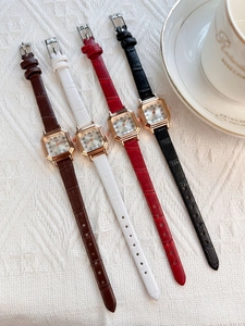 Detail of elegant square vintage women's watches with leather straps and gold cases